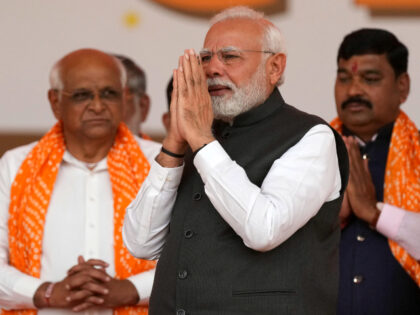 Indian Prime Minister Narendra Modi, greets the audience during the swearing in ceremony of Gujarat Chief Minister Bhupendra Patel, left, in Gandhinagar, India, Monday, Dec. 12, 2022. (AP Photo/Ajit Solanki)