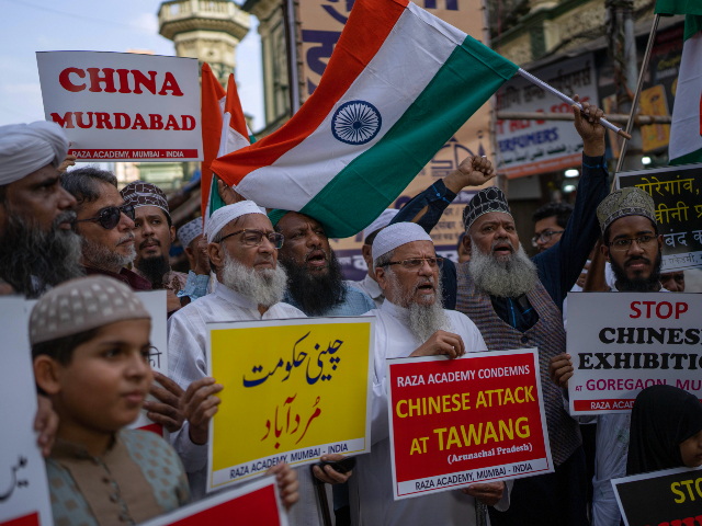 Indians hold placards as they shout slogans during a protest against China in Mumbai, India, Tuesday, Dec. 13, 2022. Soldiers from India and China clashed last week along their disputed border, India's defense minister said Tuesday, in the latest violence along the contested frontier since June 2020, when troops from both countries engaged in a deadly brawl. (AP Photo/Rafiq Maqbool)