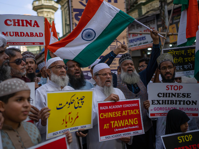 Indians hold placards as they shout slogans during a protest against China in Mumbai, India, Tuesday, Dec. 13, 2022. Soldiers from India and China clashed last week along their disputed border, India's defense minister said Tuesday, in the latest violence along the contested frontier since June 2020, when troops from both countries engaged in a deadly brawl. (AP Photo/Rafiq Maqbool)