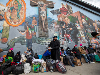 Migrants eat and wait for help while camping on a street in downtown El Paso, Texas, Sunday, Dec. 18, 2022. Texas border cities were preparing Sunday for a surge of as many as 5,000 new migrants a day across the U.S.-Mexico border as pandemic-era immigration restrictions expire this week, setting …