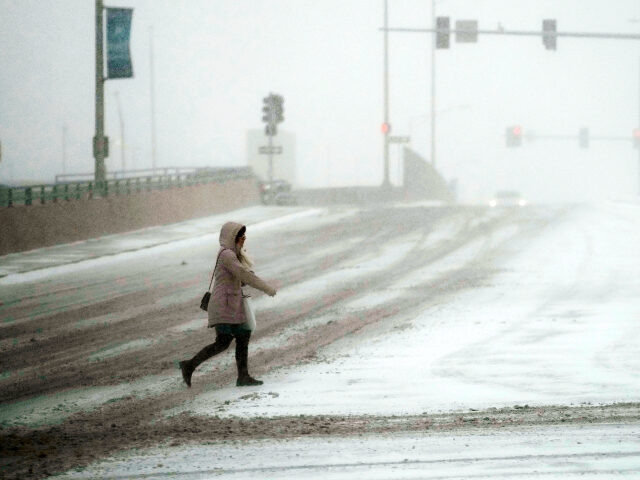 A pedestrian walks a cross the street in Rosemont, Thursday, Dec. 22, 2022. Frigid air is