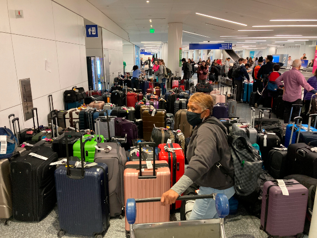 Baggage waits to be claimed after canceled flights at the Southwest Airlines terminal at Los Angeles International Airport on Monday, Dec. 26, 2022, in Los Angeles. (AP Photo/Eugene Garcia)