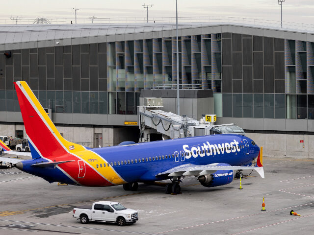 Southwest Airlines' aircraft parked on the tarmac of LaGuardia Airport, Tuesday, Dec. 27, 2022, in New York. The U.S. Department of Transportation says it will look into flight cancellations by Southwest Airlines that have left travelers stranded at airports across the country amid an intense winter storm. (AP Photo/Yuki Iwamura)