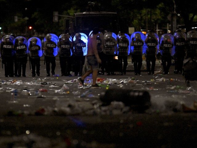 Riot police stand guard after clashes with fans of Argentina following the celebration of