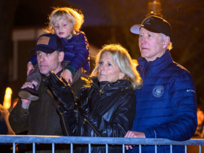 US President Joe Biden and First Lady Jill Biden watch a Christmas tree lighting ceremony with the President' son Hunter Biden and his son Beau Jr. on his shoulders during their family's Thanksgiving holiday in Nantucket, Massachusetts, on November 25, 2022. (Photo by Mandel NGAN / AFP) (Photo by MANDEL …