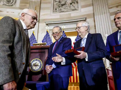 WASHINGTON, DC - DECEMBER 06: Senate Minority Leader Mitch McConnell (R-KY) (second from right) holds out his hand for a handshake with Charles Sicknick (L), the father of Capitol Police officer Brian Sicknick who died after the events of January 6, during a Congressional Gold Medal Ceremony for U.S. Capitol …
