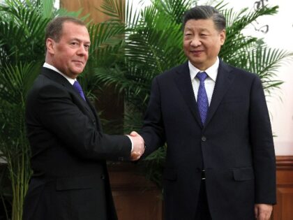 Deputy head of Russia's Security Council and chairman of the United Russia party, Dmitry Medvedev, left, and Chinese President Xi Jinping shake hands during their meeting in Beijing, China, Wednesday, Dec. 21, 2022. (Ekaterina Shtukina, Sputnik, Kremlin Pool Photo via AP)