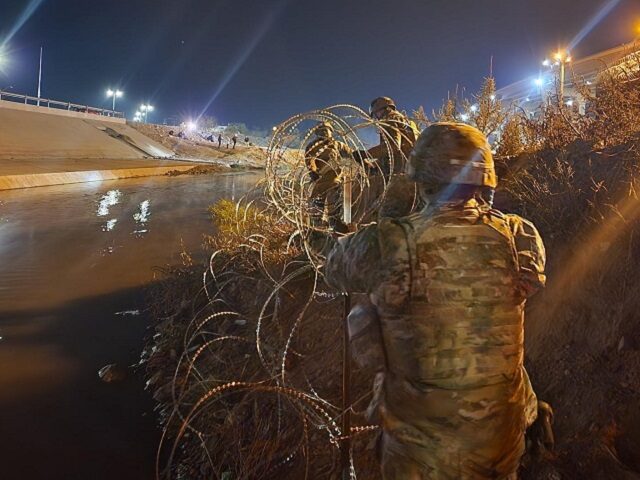 Texas National Guard Soldiers deploy razor wire along the Rio Grande in El Paso. (Texas Military Department)