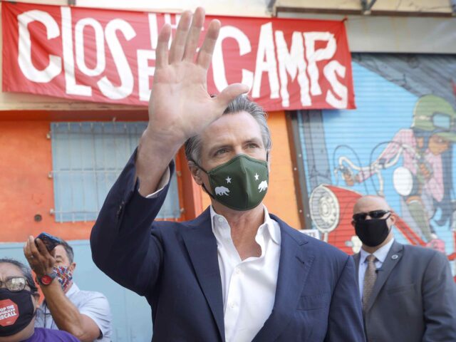 Gavin Newsom waves (Justin Sullivan / Getty)