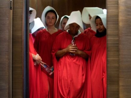 Women dressed as characters from the novel-turned-TV series "The Handmaid's Tale" stand in an elevator at the Hart Senate Office Building as Supreme Court nominee Brett Kavanaugh starts the first day of his confirmation hearing in front of the US Senate on Capitol Hill in Washington DC, on September 4, …
