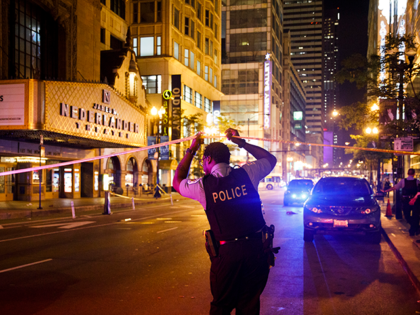 An officer walks under police tape near the intersection of West Randolph and North State Street near the scene where a woman and man were stabbed on the 100 block of East Washington Street Sunday July 7, 2019, in Chicago. (Armando L. Sanchez/Chicago Tribune/Tribune News Service via Getty Images)