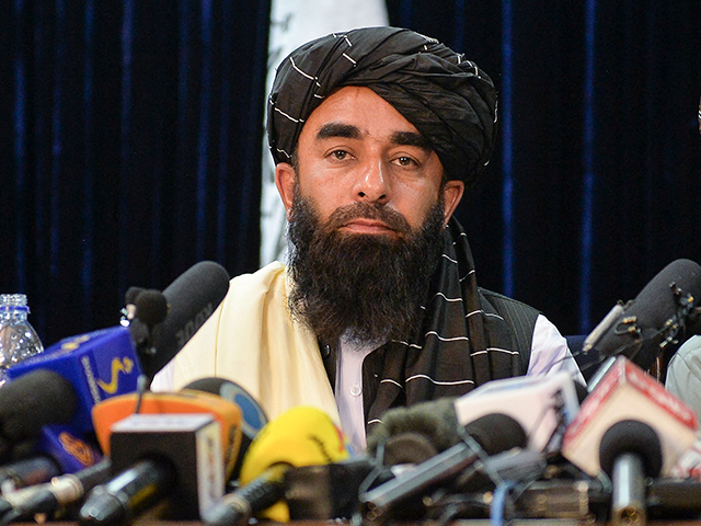 Taliban spokesperson Zabihullah Mujahid looks on as he addresses the first press conferenc