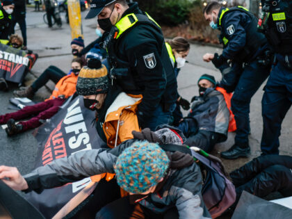 BERLIN, GERMANY - JANUARY 24: Police officers move activists blocking the end of a highway