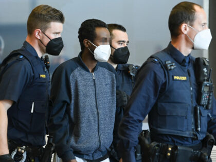 Somali defendant Abdirahman J. arrives at the start of his trial for stabbing three women in the courtroom of Veilshoechheim, near Wuerzburg, southern Germany, on April 22, 2022 - The defendant is said to have fatally stabbed three women on June 25, 2021 in Wuerzburg, prosecutors suspected an Islamist motive …