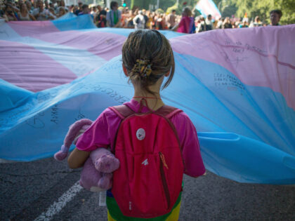 MADRID, SPAIN - 2022/07/09: A girl holds the Transgender Pride flag during the pride march held in one of the most important streets of Madrid. Thousands of people participated in the Madrid pride parade. After two years the march returned to normal with its floats that have characterised it years …