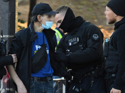 French police officers control a man at the Forceval garden square during the dismantling