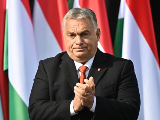 Hungary's Prime Minister Viktor Orban applauds after delivering a speech, during an event to commemorate the 66th anniversary of the Hungarian uprising against the Soviet occupation, in front of the Mindszethyneum House, a newly inaugurated memorial of the clerical leader of the revolution, cardinal Jozsef Mindszenthy, in Zalaegerszeg, Hungary, on …