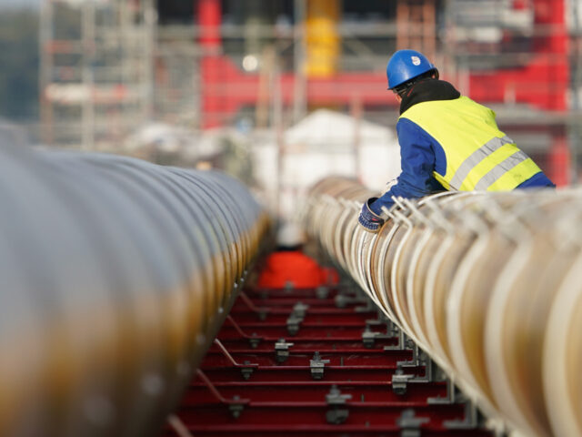 15 November 2022, Schleswig-Holstein, Brunsbüttel: Workers assemble gas pipelines for the