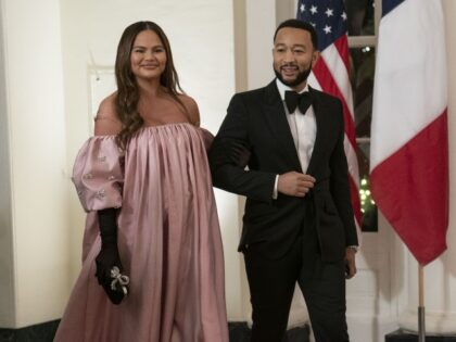 Musician John Legend, right, and model Chrissy Teigen arrive to attend a state dinner in honor of French President Emmanuel Macron and Brigitte Macron hosted by US President Joe Biden and First Lady Jill Biden at the White House in Washington, DC, US, on Thursday, Dec. 1, 2022. Biden said …