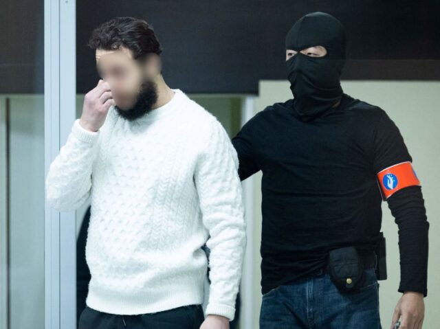 Defendant Salah Abdeslam arrives under police escort for the trial of alleged jihadists a