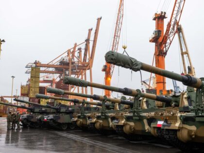 Polish Army soldiers stand in front of army equipment in the port after the arrival of the first K2 tanks and K9 howitzers for Poland on December 6, 2022 at the Baltic Container Terminal in Gdynia. - The Polish Army is strengthening its potential with the use of South Korean …