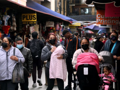 LOS ANGELES, CA - DECEMBER 6, 2022 - - Shoppers, some wearing masks, some not, make their way along Santee Alley in Los Angeles on December 6, 2022. Los Angeles County appears in the midst of another full-blown coronavirus surge, with cases rising by 75% over the last week. The …