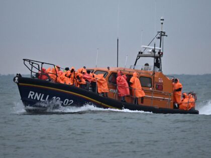 Migrants, picked up at sea attempting to cross the English Channel from France, are brought ashore on a Royal National Lifeboat Institution (RNLI) lifeboat at Dungeness on the southeast coast of England, on June December 9, 2022. (Photo by Ben Stansall / AFP) (Photo by BEN STANSALL/AFP via Getty Images)