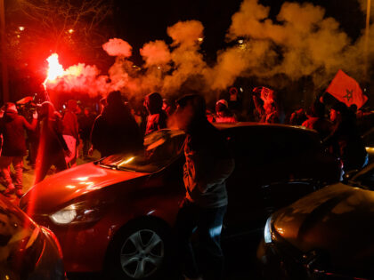 PARIS, FRANCE - DECEMBER 10: Moroccan fans celebrate in Champs Elysees after Moroccan foot