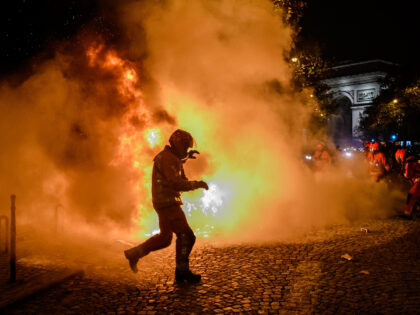 PARIS, FRANCE - DECEMBER 10: Fire is seen on the streets of Champs Elysees after Moroccan