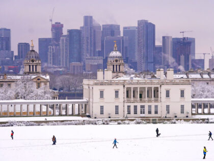 People walk through the snow in Greenwich Park, south-east London. Snow and ice have swept