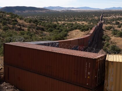 Shipping containers line the US and Mexico Border at Coronado National Memorial in Cochise County, Arizona, US, on Sunday, Dec. 11, 2022. The US government and Arizona environmentalists are fighting outgoing Governor Doug Ducey's ongoing effort to wall off sections of the states border with Mexico using state-purchased shipping containers, …