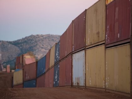 Shipping containers line the US and Mexico Border at Coronado National Memorial in Cochise County, Arizona, US, on Saturday, Dec. 10, 2022. The US government and Arizona environmentalists are fighting outgoing Governor Doug Ducey's ongoing effort to wall off sections of the state’s border with Mexico using state-purchased shipping containers, …
