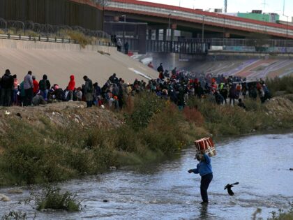 Migrants walk across the Rio Grande to surrender to US Border Patrol agents in El Paso, Texas, as seen from Ciudad Juarez, Chihuahua state, Mexico, on December 13, 2022. (Photo by Herika Martinez / AFP) (Photo by HERIKA MARTINEZ/AFP via Getty Images)