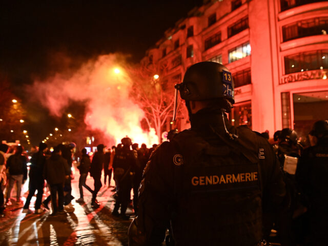 PARIS, FRANCE - DECEMBER 15: Fans clash with police as fans of France celebrate victory af