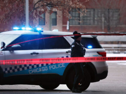 Chicago police secure a crime scene on the campus of Benito Juarez Community Academy high school in Chicago where four people were shot after school on Dec. 16, 2022. Two of the four died. (Terrence Antonio James/The Chicago Tribune/Tribune News Service via Getty Images)