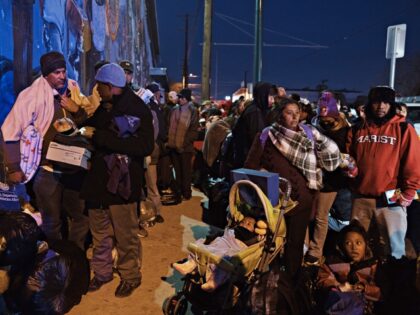 Migrants wait to enter the shelter of the Sacred Heart Church near the US and Mexico border in El Paso, Texas, US, on Tuesday, Dec. 20, 2022. Chief Justice John Roberts temporarily blocked the scheduled ending of pandemic-era border restrictions while the US Supreme Court considers a bid by Republican …
