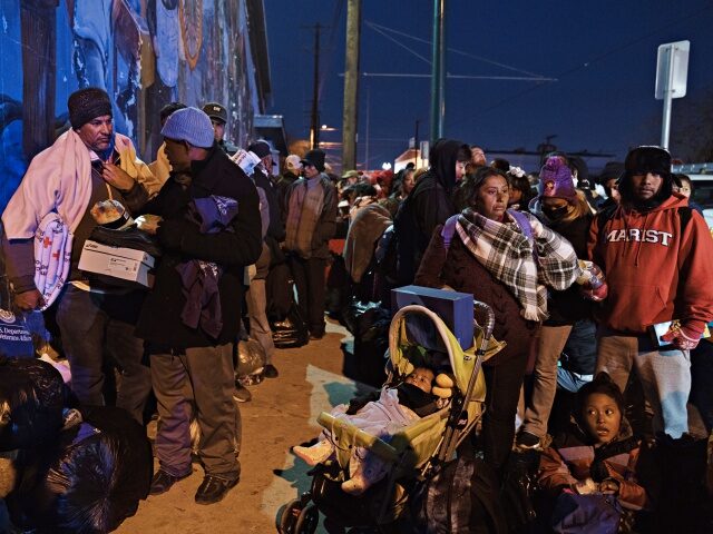 Migrants wait to enter the shelter of the Sacred Heart Church near the US and Mexico borde