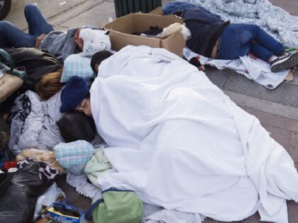 Migrants sleep outside the Greyhound bus station near the US and Mexico border in El Paso, Texas, US, on Tuesday, Dec. 20, 2022. Chief Justice John Roberts temporarily blocked the scheduled ending of pandemic-era border restrictions while the US Supreme Court considers a bid by Republican state officials to keep …