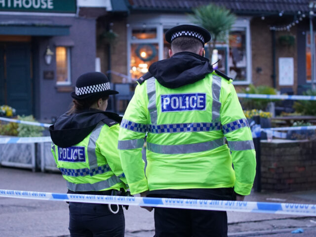 Police officers on duty at the Lighthouse Inn in Wallasey Village, near Liverpool, after a