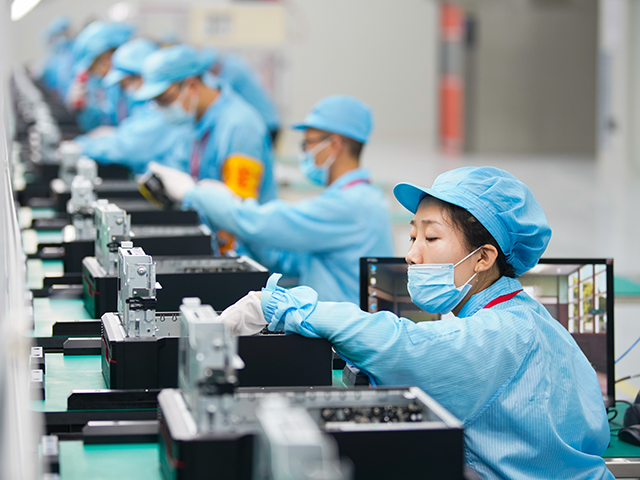 Employees work on the assembly line of computers at a new factory of China Greatwall Techn