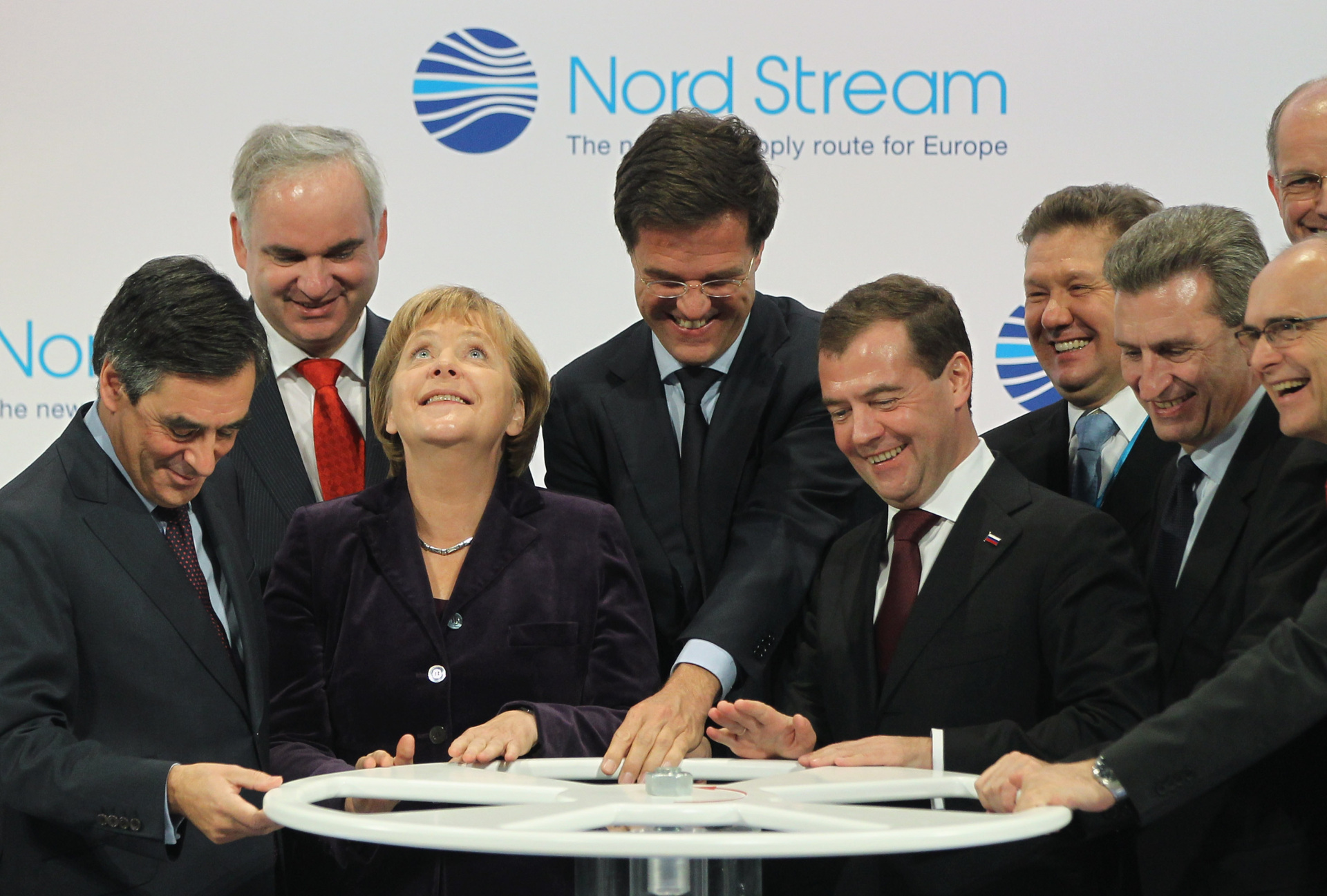 LUBMIN, GERMANY - NOVEMBER 08: (From L to R, first row) French Prime Minister Francois Fillon, German Chancellor Angela Merkel, Dutch Prime Minister Mark Rutte, Russian President Dmitry Medvedev and European Union Energy Commissioner Guenther Oettinger turn a wheel to symbolically start the flow of gas through the Nord Stream Baltic Sea gas pipeline at a cemerony on November 8, 2011 in Lubmin, Germany. The Nord Stream pipeline runs through the Baltic Sea and will supply Europe with natural gas from Russia. (Photo by Sean Gallup/Getty Images)
