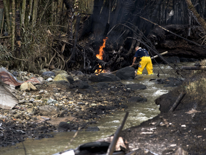 A firefighter tries to put out a fire on the banks of the Agua Azul river that caught fire because of the explosion of a pipeline, on December 23, 2011, in Dosquebradas, department of Risaralda, Colombia. At least 11 people were killed and more than 80 others were injured Friday …