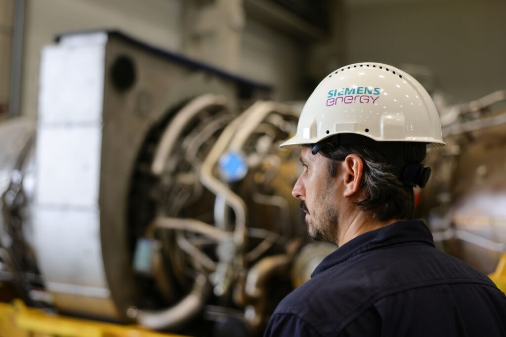 MUELHEIM AN DER RUHR, GERMANY - AUGUST 03: A Siemens Energy technician looks at the Siemens gas turbine intended for the Nord Stream 1 gas pipeline in Russia at a Siemens Energy facility on August 03, 2022 in Muelheim an der Ruhr, Germany. The turbine underwent maintenance in Canada and was supposed to already be delivered to Russia for installation back into the pipeline, but Russian energy company Gazprom has so far refused to accept the repaired turbine, citing insufficient documentation. German authorities have refuted Gazprom's claim and say the Russian government is stalling. Russia is still supplying gas to Germany via Nord Stream 1, albeit at a much reduced flow. The two countries are at odds over the ongoing Russian war in Ukraine. (Photo by Andreas Rentz/Getty Images)