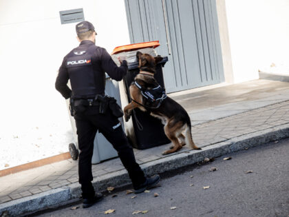 MADRID, SPAIN - DECEMBER 02: A National Police officer and a body dog in the vicinity of the Ukrainian embassy after it was cordoned off, Dec. 2, 2022, in Madrid, Spain. The Ukrainian Embassy in Madrid has been cordoned off and cleared after receiving a new suspicious package with traces …