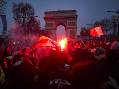 PARIS, FRANCE - DECEMBER 18: French football fans chant and sing on the Champs Elysees as France plays Argentina in the final of the Fifa World Cup on December 18, 2022 in Paris, France. France lost to Argentina on penalties after drawing 3-3 after extra time despite French forward Kylian …