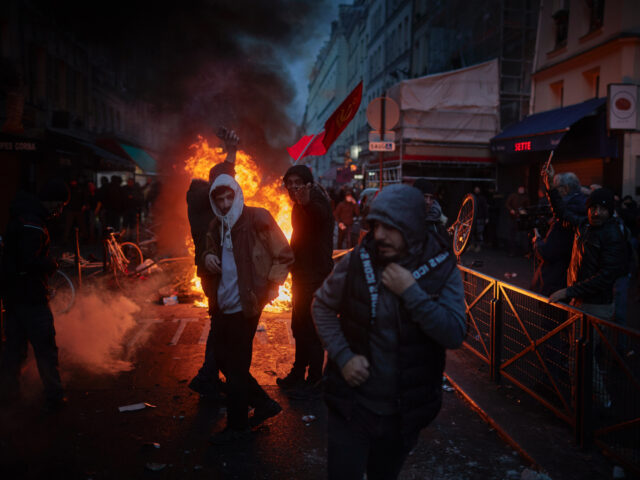 PARIS, FRANCE - DECEMBER 23: Angry protestors face off towards French Riot Police after vi