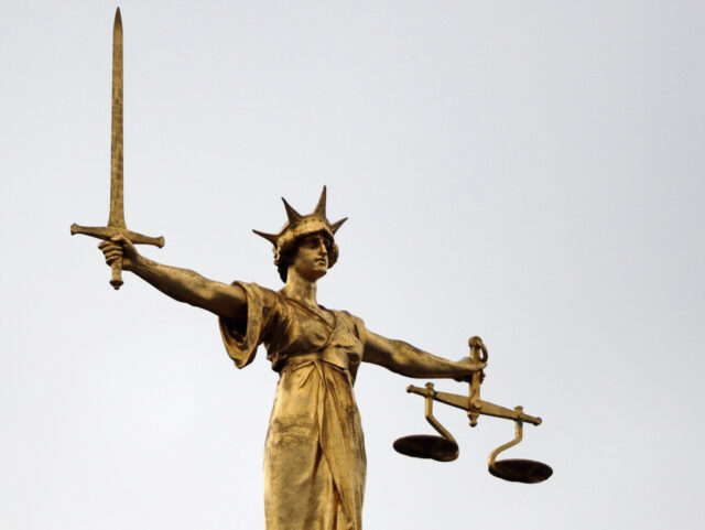 LONDON, ENGLAND - FEBRUARY 16: A statue of the scales of justice stands above the Old Bail
