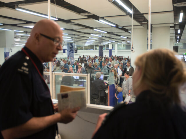 LONDON, ENGLAND - MAY 28: Border Force staff monitor the checking of passports of passengers arriving at Gatwick Airport from their control room on May 28, 2014 in London, England. Border Force is the law enforcement command within the Home Office responsible for the security of the UK border by …