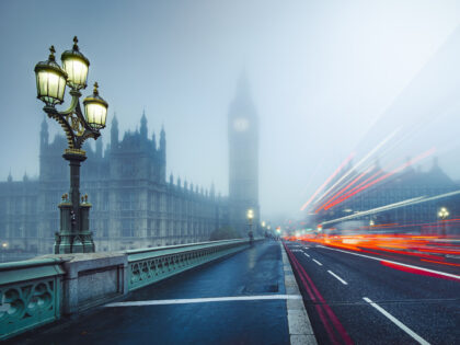 Traffic leaves trails of light across Westminster Bridge with Big Ben and the Houses of Pa