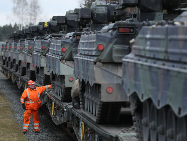 GRAFENWOEHR, GERMANY - FEBRUARY 21: A railway worker checks Marder light tanks of the Bundeswehr, the German armed forces, after they had been loaded onto a train for transport to Lithuania on February 21, 2017 in Grafenwoehr, Germany. The Bundeswehr is participating in the enhanced Forward Presence operation of NATO, …
